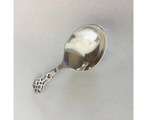 A Sterling silver pierced caddy spoon. Approx. 10 grams. Est. £30 - £50.