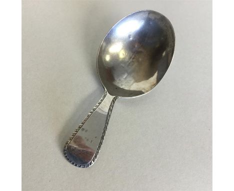 A Georgian silver bright cut caddy spoon with feather edge decoration. London. By WC. Approx. 9 grams. Est. £30 - £50.