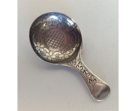 A good quality Georgian silver bright cut caddy spoon decorated with flowers and leaves. Birmingham. By JL. Approx. 5 grams. 