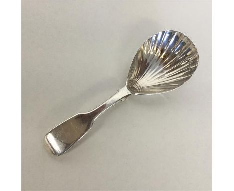 A large Victorian silver caddy spoon with fluted bowl. London. By WE. Approx. 16 grams. Est. £30 - £50.