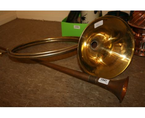 Brass French horn together with another copper hunting horn