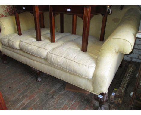 Large antique style damask upholstered humpback sofa with three loose cushions, raised on carved and cabriole claw and ball f