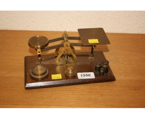 Small pair of early 20th Century oak and brass postal scales with weights