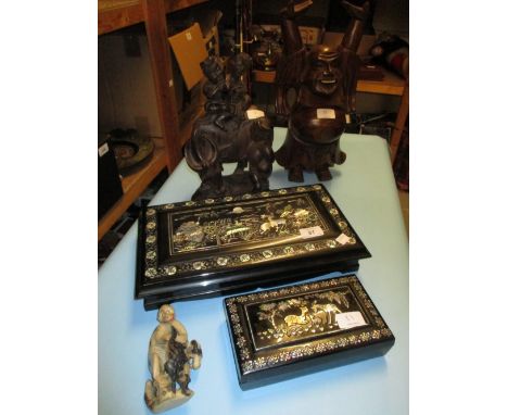 Two modern Chinese black lacquer and mother of pearl decorated boxes, two similar hardwood carvings and a soapstone carving