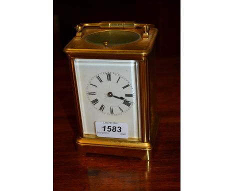 Early 20th Century brass cased carriage clock, the enamel dial with Roman numerals, the two train movement with hour repeat f