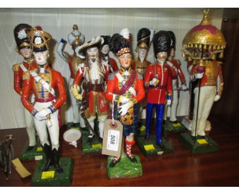 Set of eleven Sitzendorf porcelain figures, mainly Napoleonic soldiers on green square plinth bases, together with another si