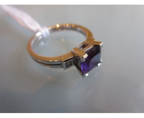 18ct White gold ring set square amethyst flanked by diamond set shoulders