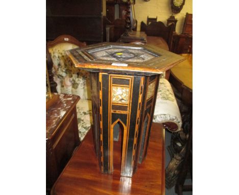 Hexagonal Moorish mother of pearl and line inlaid ebonised low table on shaped supports