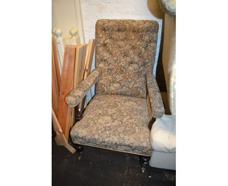 19th Century mahogany open arm library chair having button upholstered back, raised on turned tapering front supports with br
