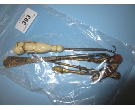 Five various 19th Century button hooks including the devil and a rowing boat