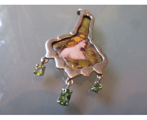 Art Nouveau silver mounted and ceramic pendant decorated with a semi nude figure of a lady with green gemstone set drops