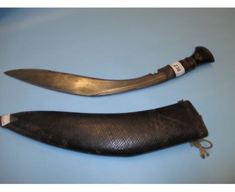 Indian kukri with a leather scabbard together with a native carved wooden comb