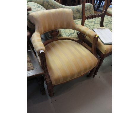 19th Century walnut tub chair with carved and reeded decoration, raised on turned tapering front supports with brass and cera
