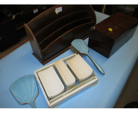 Blue enamel three piece dressing table set, an Art Deco ivory brush set with tray, mahogany tea caddy and a letter rack