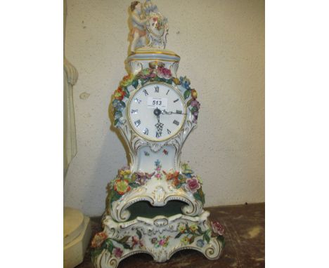 Large mid 20th Century Continental porcelain floral encrusted mantel clock with Roman numerals, figural surmount and separate