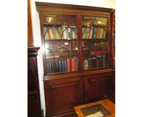 George III mahogany bookcase, the moulded dentil cornice above a pair of bar glazed doors, the base with a moulded top above 