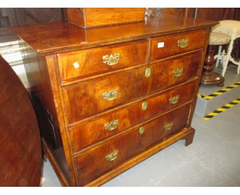 George I walnut and oak chest of two short and three long drawers with brass handles and escutcheons raised on bracket suppor