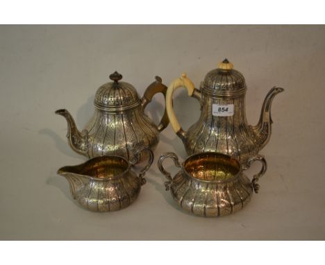 Victorian silver four piece tea service by Garrards, the baluster bodies with chased decoration, the cream jug and sugar bowl