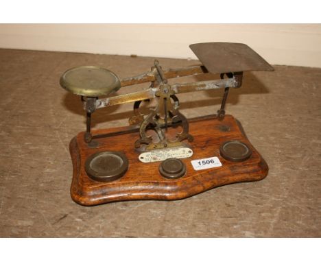 Pair of oak and brass mounted balance scales with weights