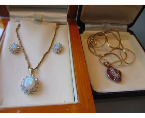 9ct Gold ruby style pendant on chain, together with a 9ct gold opal and paste set pendant with matching earrings