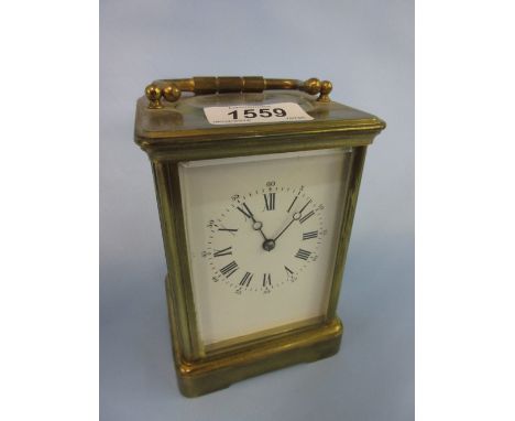 Early 20th Century brass cased carriage clock, the enamel dial with Arabic and Roman numerals and single train movement