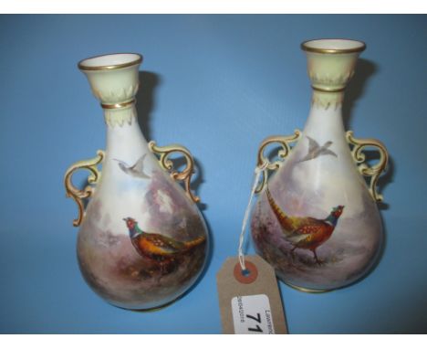 Pair of Royal Worcester two handled baluster form vases decorated with pheasants in landscapes, signed Stinton