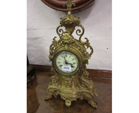 19th Century French gilt brass mantel clock with urn surmount, the ceramic dial with Roman numerals, the two train movement s