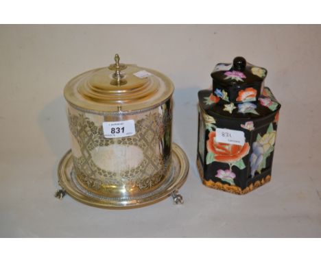 19th Century silver plated floral engraved circular biscuit barrel with cover together with a floral decorated ceramic teapoy