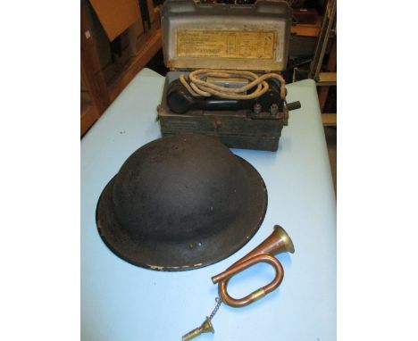 World War II field telephone, mark II Tommy helmet and a small bugle