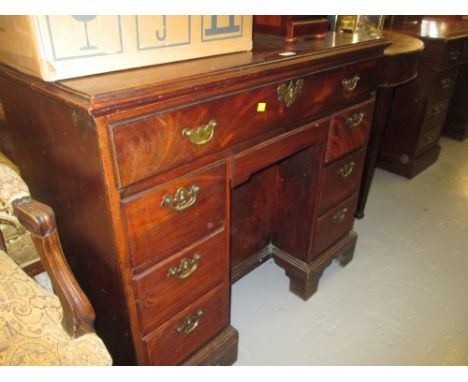 George III mahogany kneehole desk, the moulded top above an arrangement of eight drawers surrounding a central kneehole cupbo