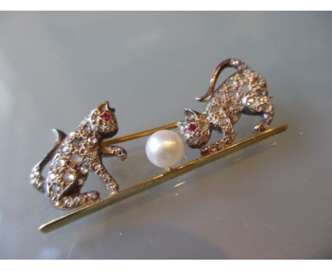 Diamond, ruby and cultured pearl set bar brooch in the form of two cats playing with a ball