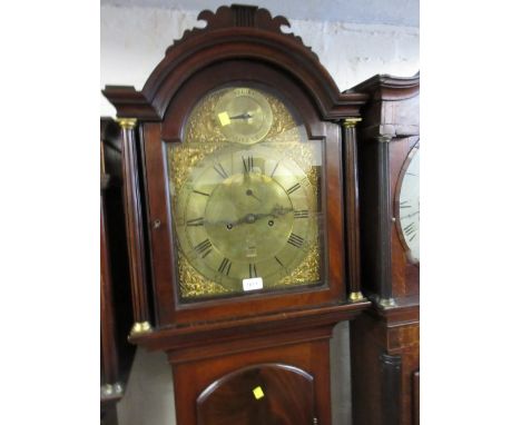 George III mahogany longcase clock with an arched hood above arched panel door and a plinth base, the brass dial with strike 