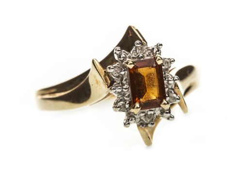 ORANGE GEM AND DIAMOND RING, the step cut orange gem within a border of round brilliant cut diamonds, the diamonds totalling 