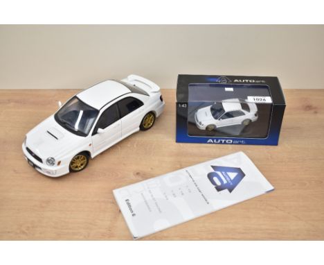 Two Auto Art Die-casts, 1:43 scale Subaru New Age Impreza WRX STI 2001 in display box with internal packaging present and 1:1