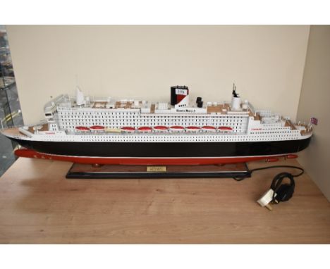 A wooden kit built scale model, Cunard Queen Mary 2, on fitted stand, length 100cm
CONDITION REPORT
No major faults, appears 