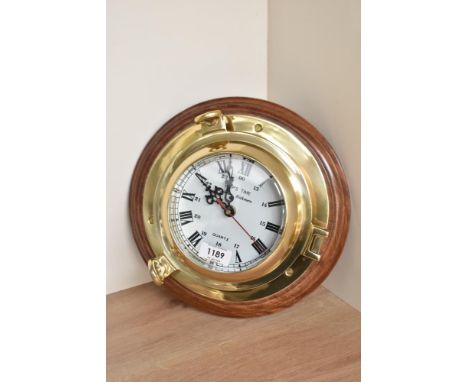 A Rickmer Rickmers Quartz Ships Time brass Porthole Ships clock with roman numeral and 13-00 dial, diameter of dial 13cm, on 