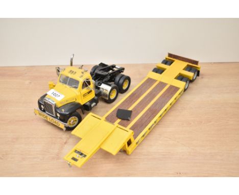 An unnamed Die-cast scale model, Case Equipment Sales And Service Wide Load Wagon and Trailer, damage seen to one mud flap