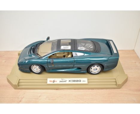 A Maisto 1:12 scale Die-cast, Jaguar XJ220 (1992), on plastic display stand