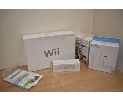 A Nintendo Wii Console with MarioKart Game and Wheel along with an extra Controller and a Gamexpert Accessory Pack, all boxed
