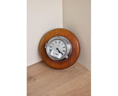 A Sestrel Alarm chrome miniature Bulk Head style Clock, roman numeral dial, dial diameter 6.5cm, on wooden mount