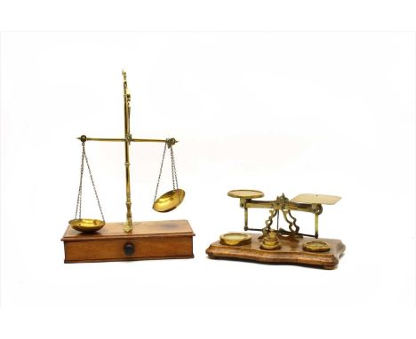 A set of mid-19th Century brass postal scales, in the manner of Sampson Mordan &amp; Co, on waknut serpentine fronted base, w