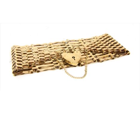 A 9ct gold ten row gate bracelet, with heart shaped padlock clasp and safety chain, London 1976, 18.89g