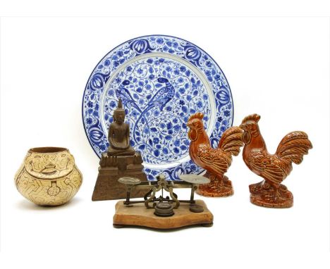 A Delft blue and white wall charger, 42cm diameter, a pair of Dartmouth cockerels, a pair of postal scales, a carved Buddha, 