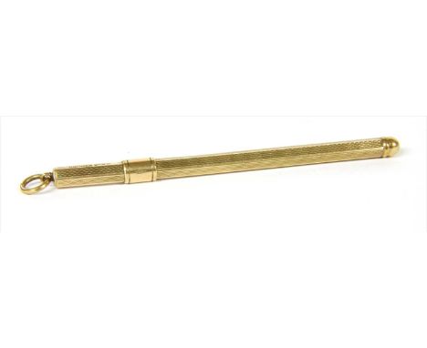 A 9ct gold cocktail swizzle stick, the propelling swizzle stick with engine turned decoration, Birmingham 1954, 6.13g