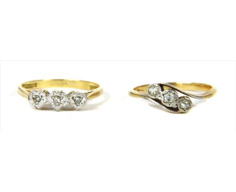 A gold three stone diamond ring, with eight cut diamonds, grain set to heart shaped illusion plates, tested as approximately 