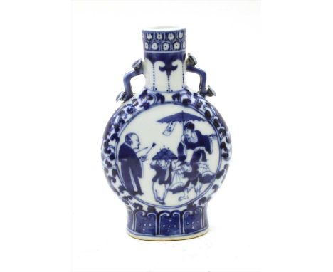 A Chinese blue and white moon flask, of compressed form, painted with merchant figures in a roundel, surrounded by scrolling 