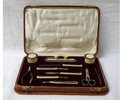 CASED IVORINE MANICURE SET
the various implements and tools with niello style decoration to the ivorine handles, in fitted le