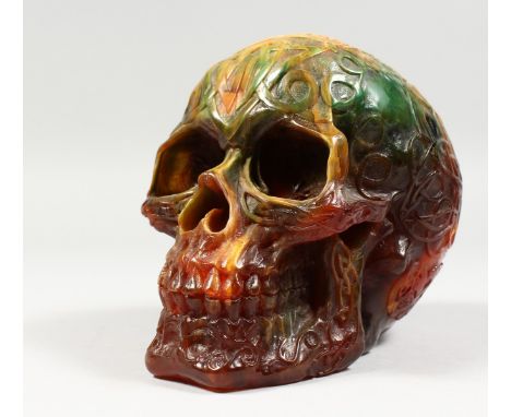 A RESIN MODEL OF A HUMAN SKULL. 7ins long.