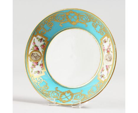 A 19TH CENTURY SEVRES STYLE SAUCER, ornately gilded with portrait heads surrounded by roses.