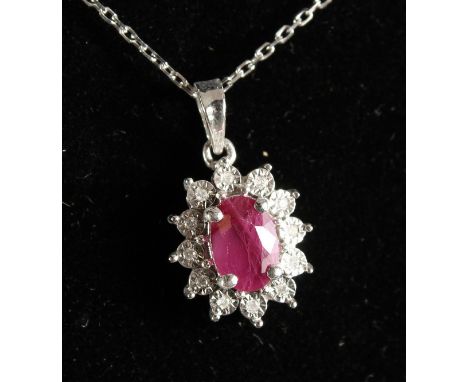 A GOOD 9CT GOLD, RUBY AND DIAMOND PENDANT ON CHAIN.